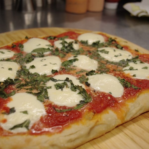 COHO Pizza & Wine Bar's Margherita pizza with fresh mozzarella, tomato sauce, and basil.